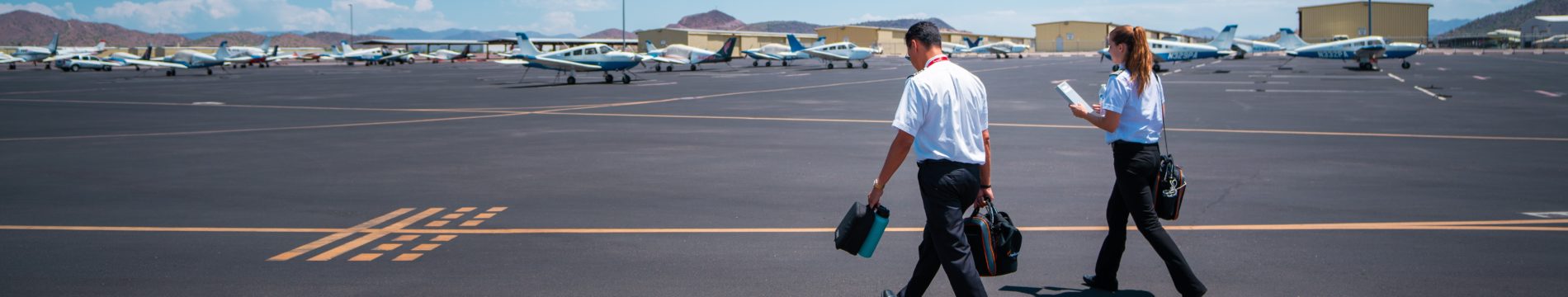 pilots carrying flight bags to plane