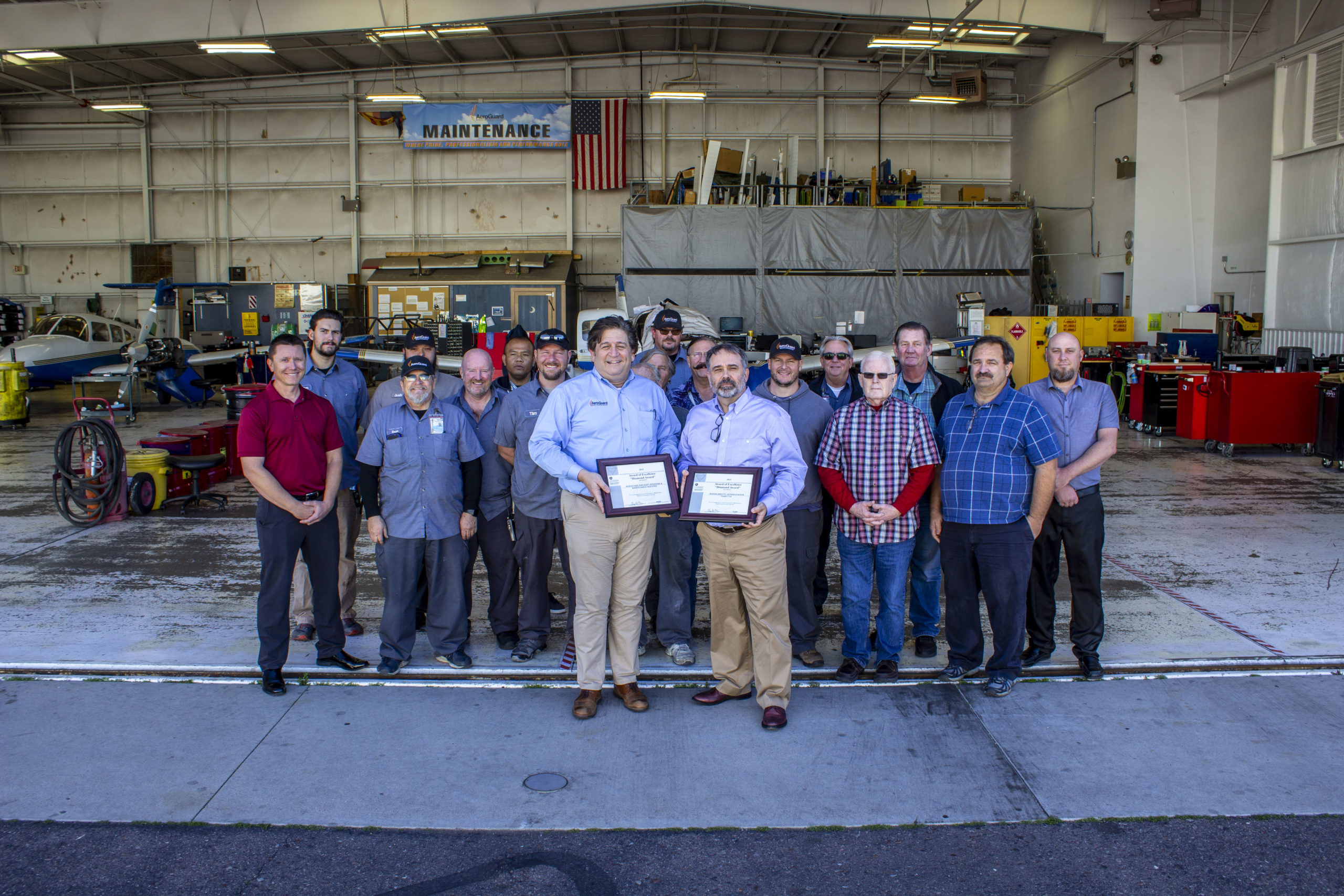 AeroGuard maintenance team accepting FAA Diamond Award in front of hangar
