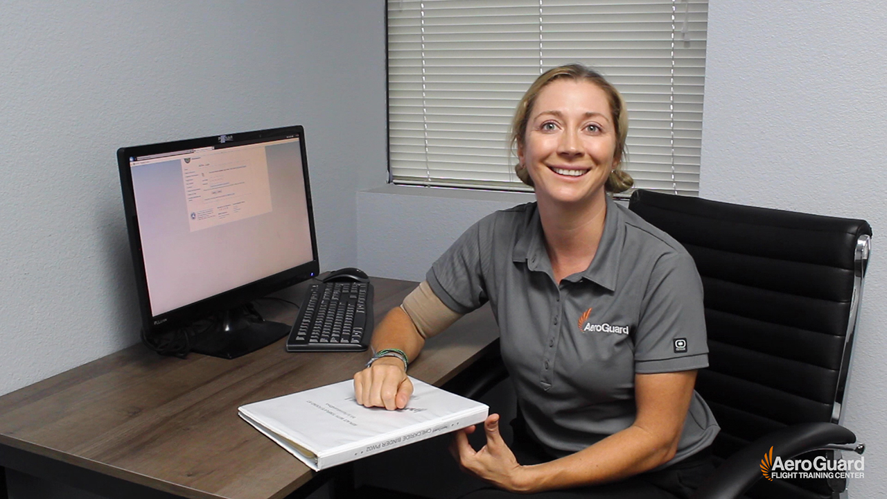 flight instructor sitting at desk showing how to create a checkride binder