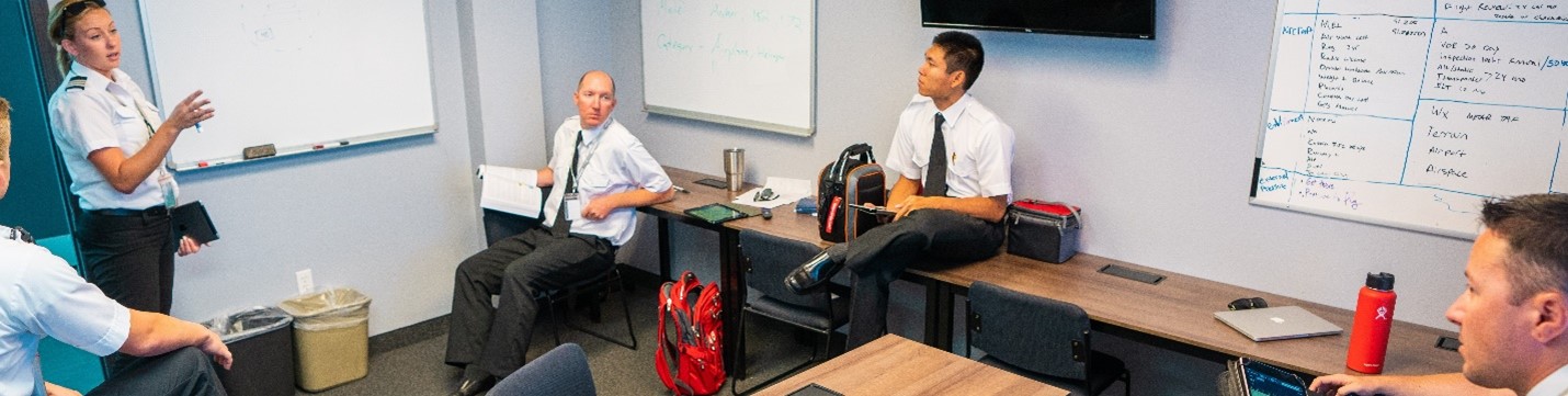 flight instructor teaching class inside classroom
